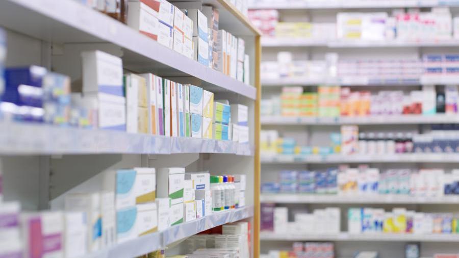 Pharmacy shelves stocked with OTC medicines